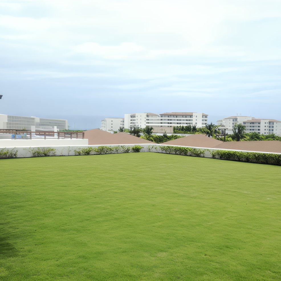 Green lawn and low hedge in front, perfect for a destination wedding; modern white buildings behind.
