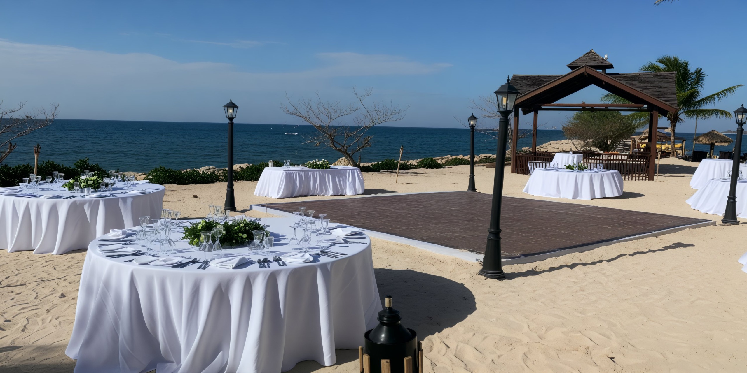 Wedding setup at Secrets Wild Orchid: a picturesque destination wedding featuring round tables, a dance floor, and a charming gazebo by the sea.