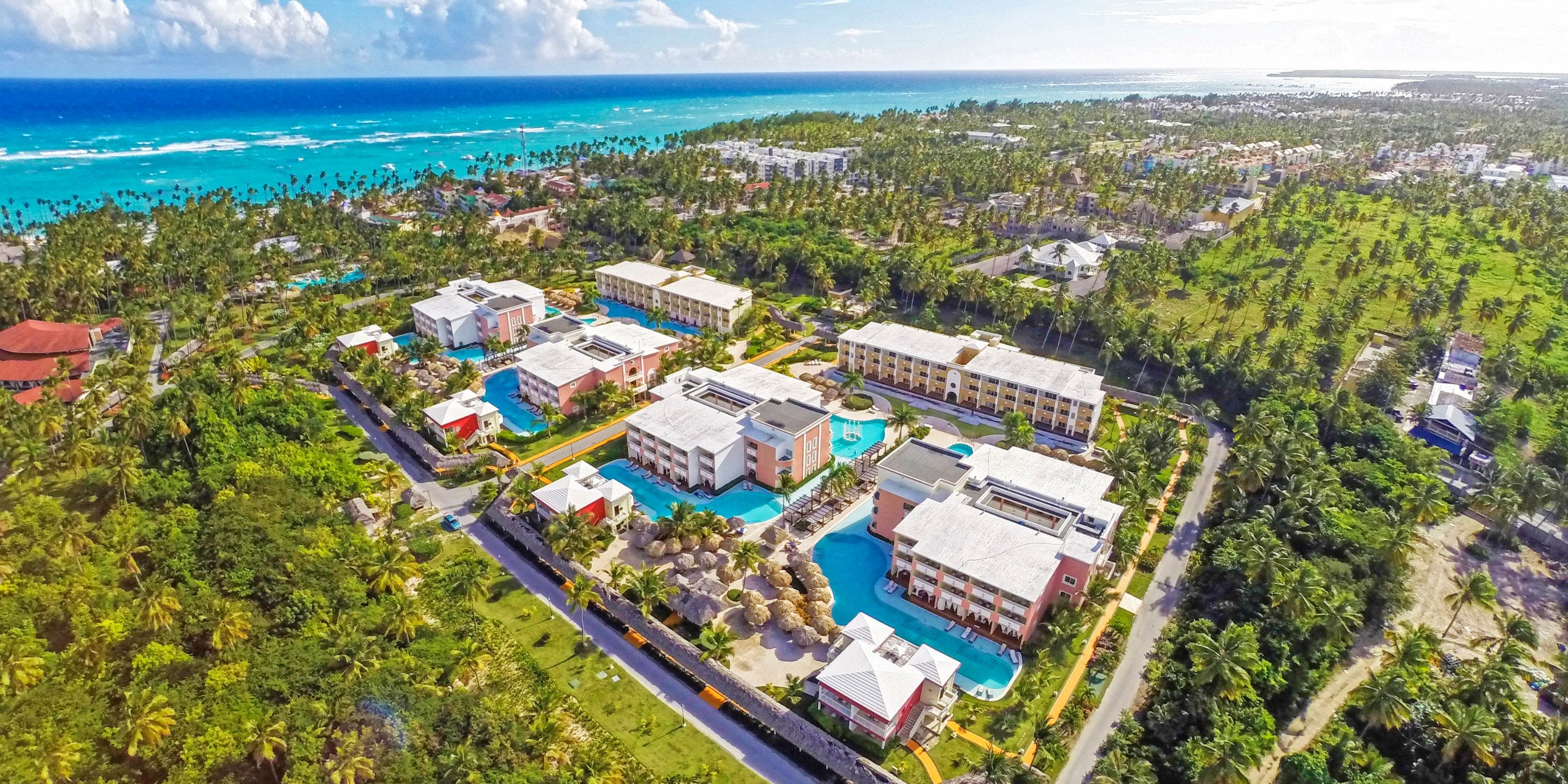 Aerial view of TRS Turquesa resort, perfect for a destination wedding, with pools, palms, and ocean.