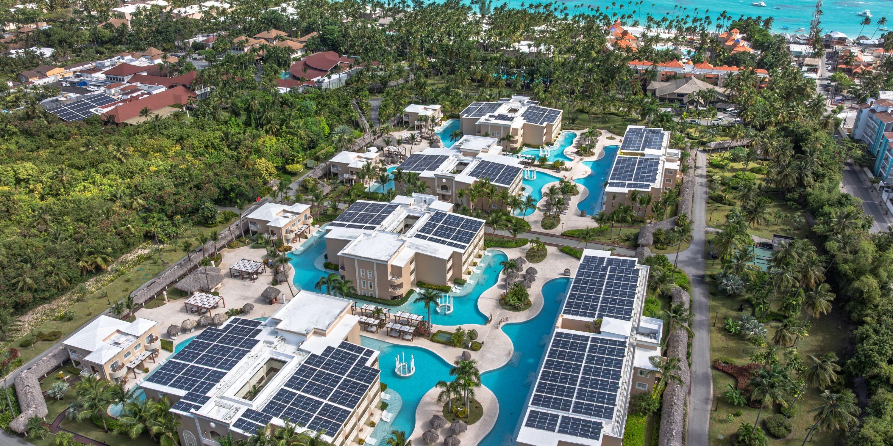 Aerial view of TRS Turquesa, perfect for a destination wedding, with solar panels and pool networks.