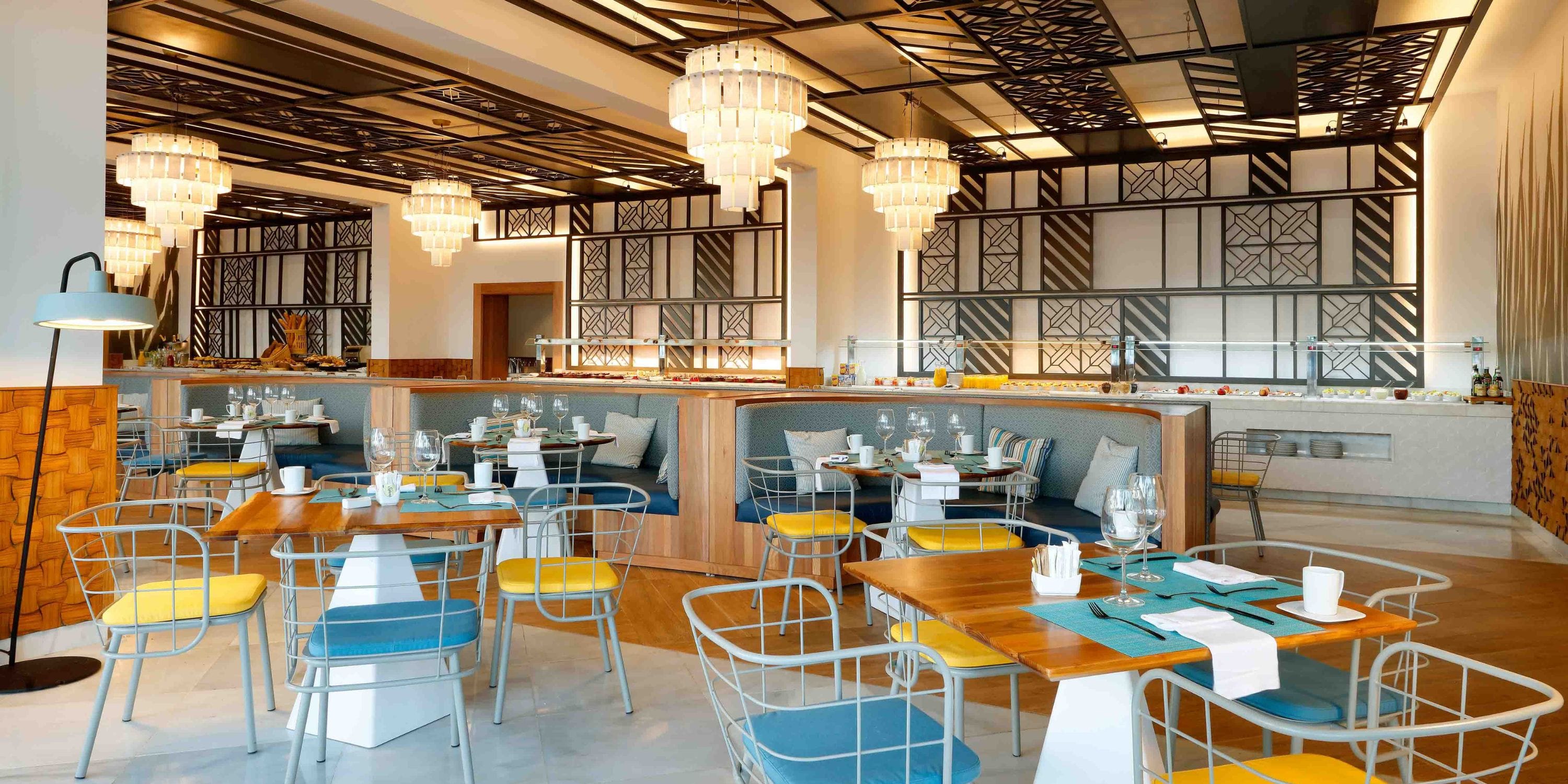 TRS Turquesa&rsquo;s chic modern interior, with chandeliers and colorful chairs, is perfect for a wedding.