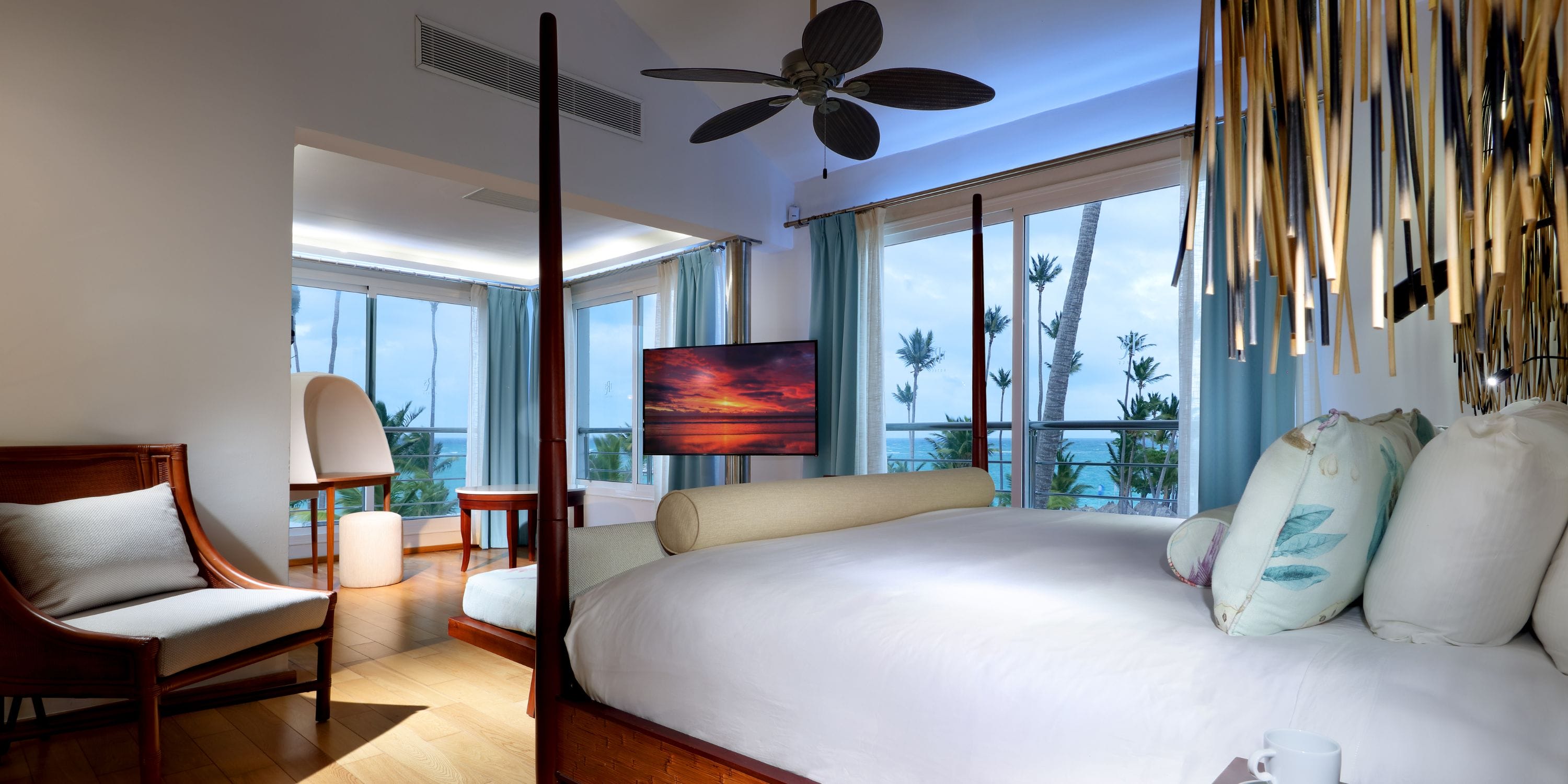 TRS Turquesa hotel room, perfect for a destination wedding, with canopy bed, ocean views, and TV.