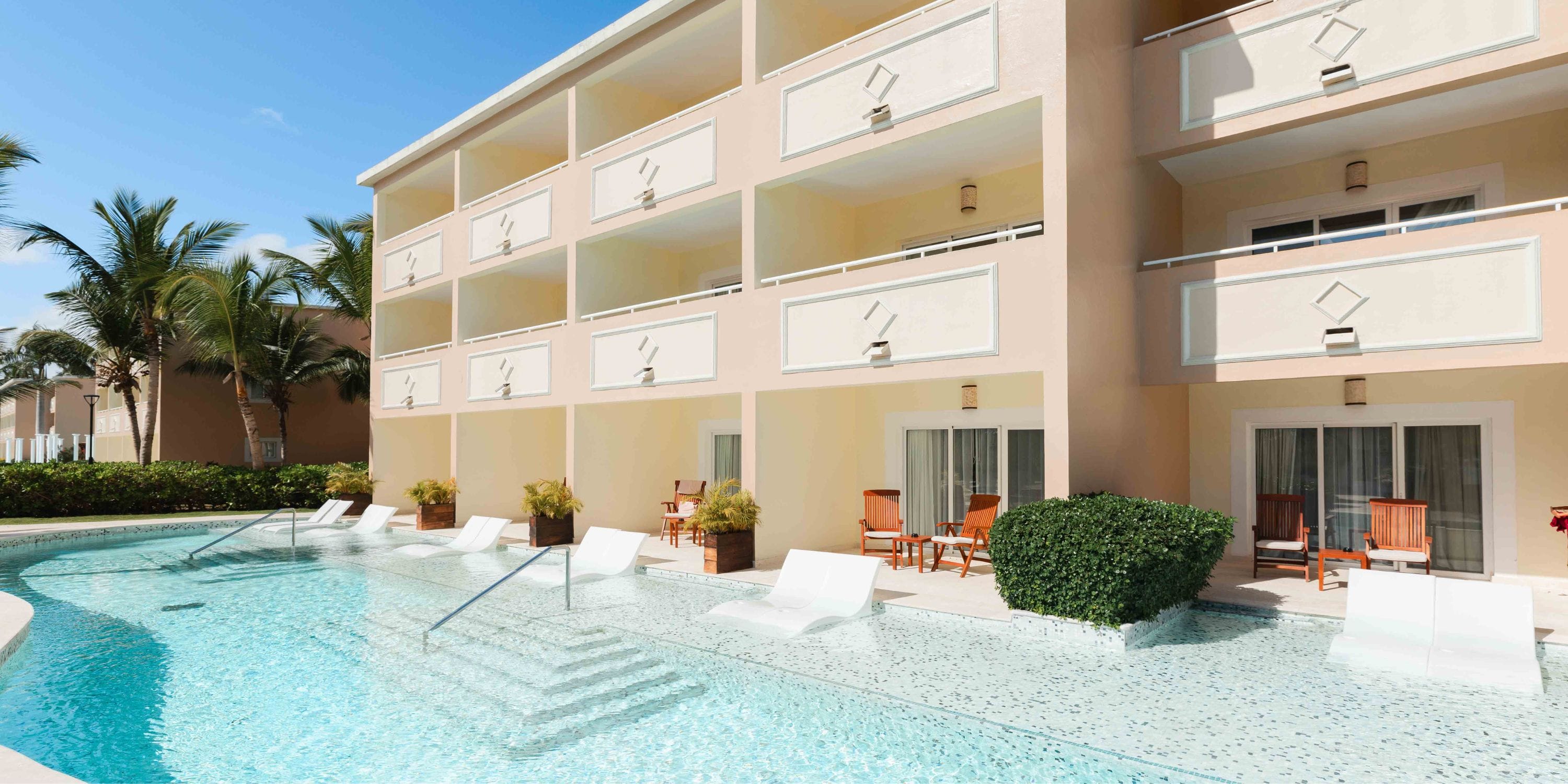TRS Turquesa: Three-story hotel perfect for destination weddings, with poolside lounge chairs and private patios.
