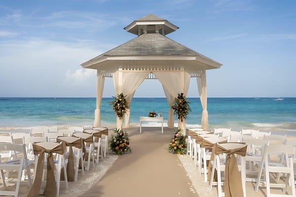 Bahia Principe Fantasia: White gazebo arranged for a destination wedding, chairs facing the ocean.