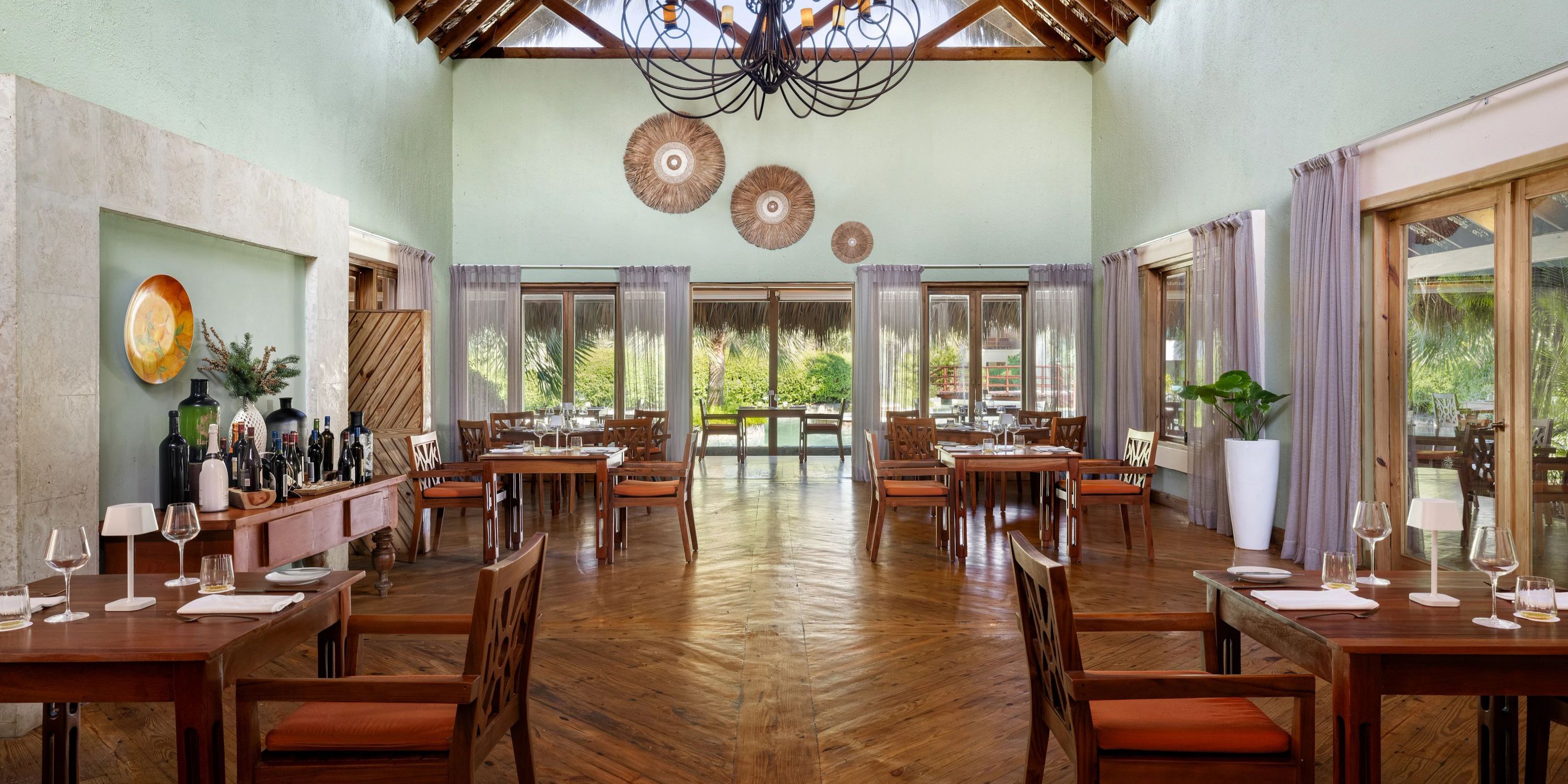 Zoetry Agua Punta Cana: Elegant venue with wooden floors and set tables, ideal for a destination wedding.