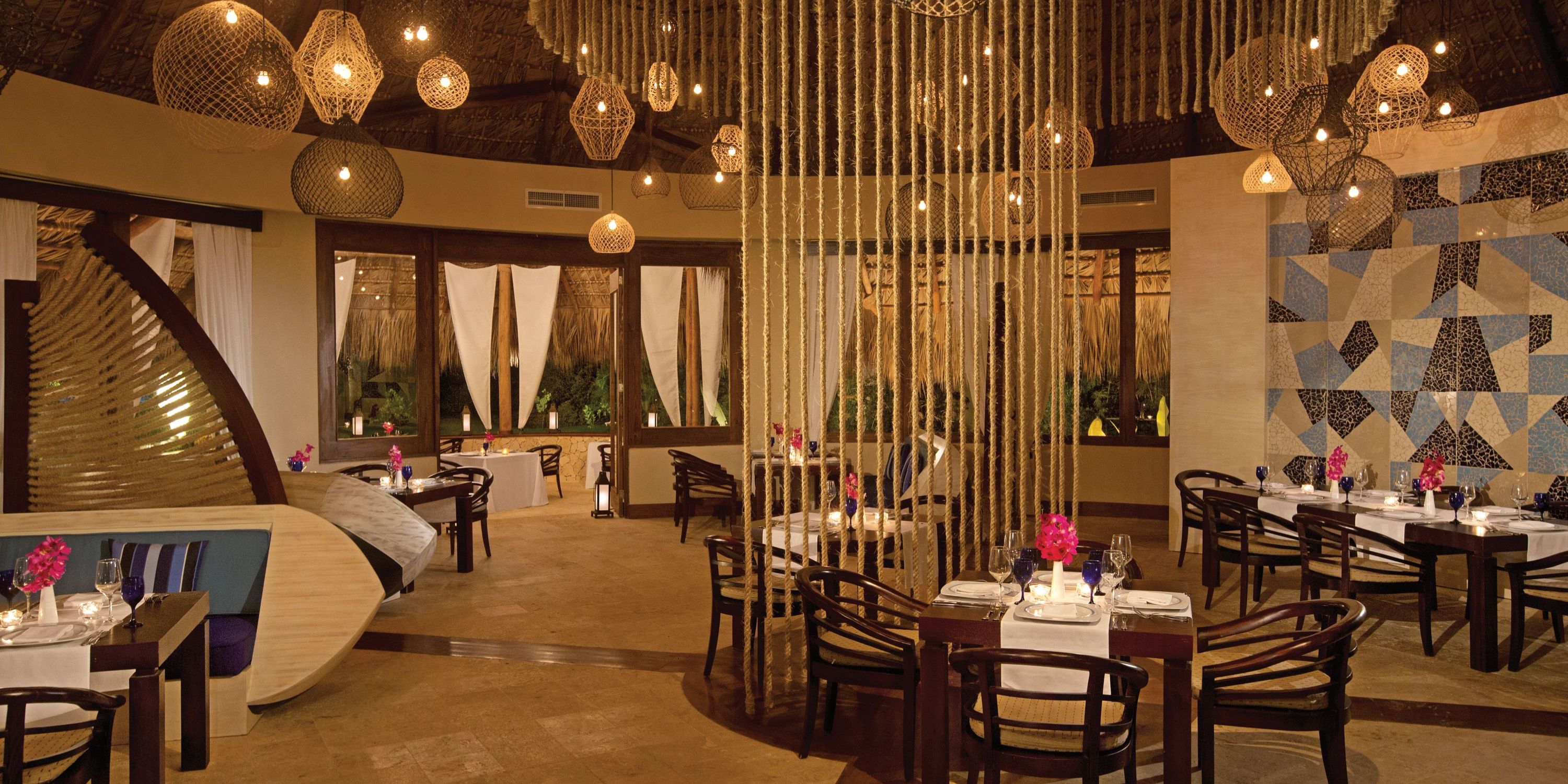 Chic Zoetry Agua Punta Cana setting with wood tables, rope divider, and lights—perfect for weddings.