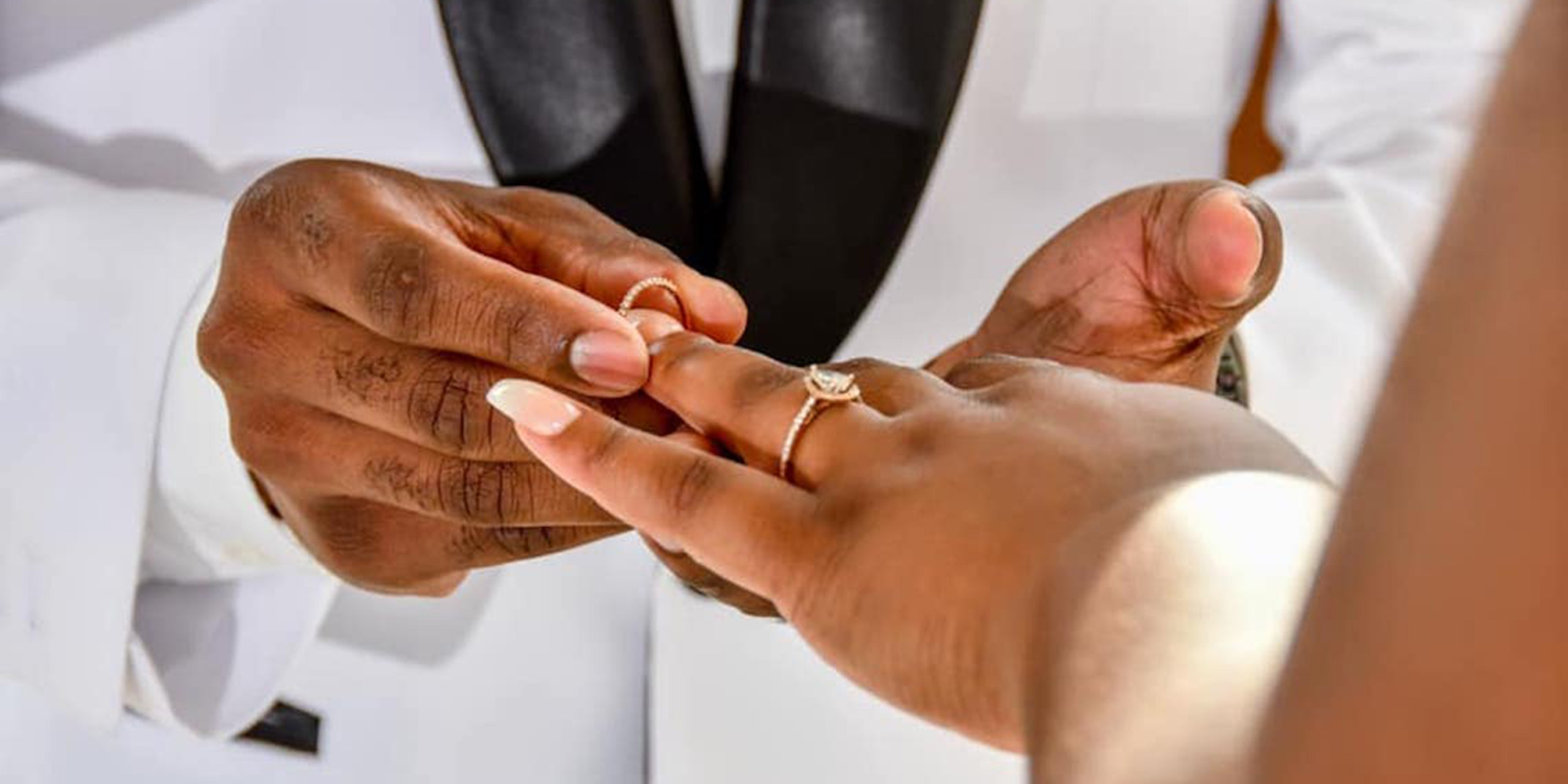 Walter puts the wedding ring on the finger of Imani at the Imani and Walter wedding