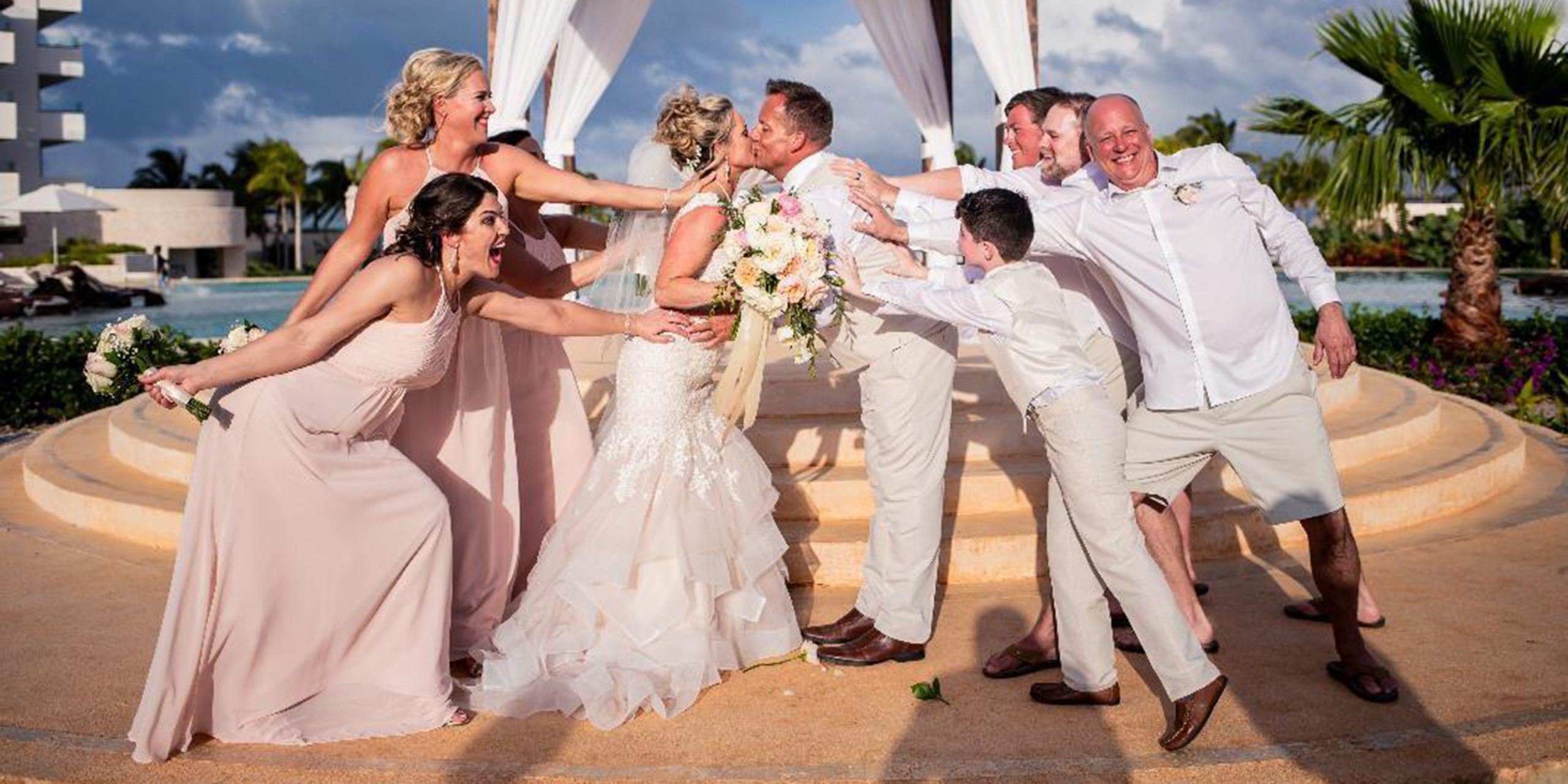 Jacqueline and Troy pose with all their funny friends and family bridesmaids and groomsmen and son