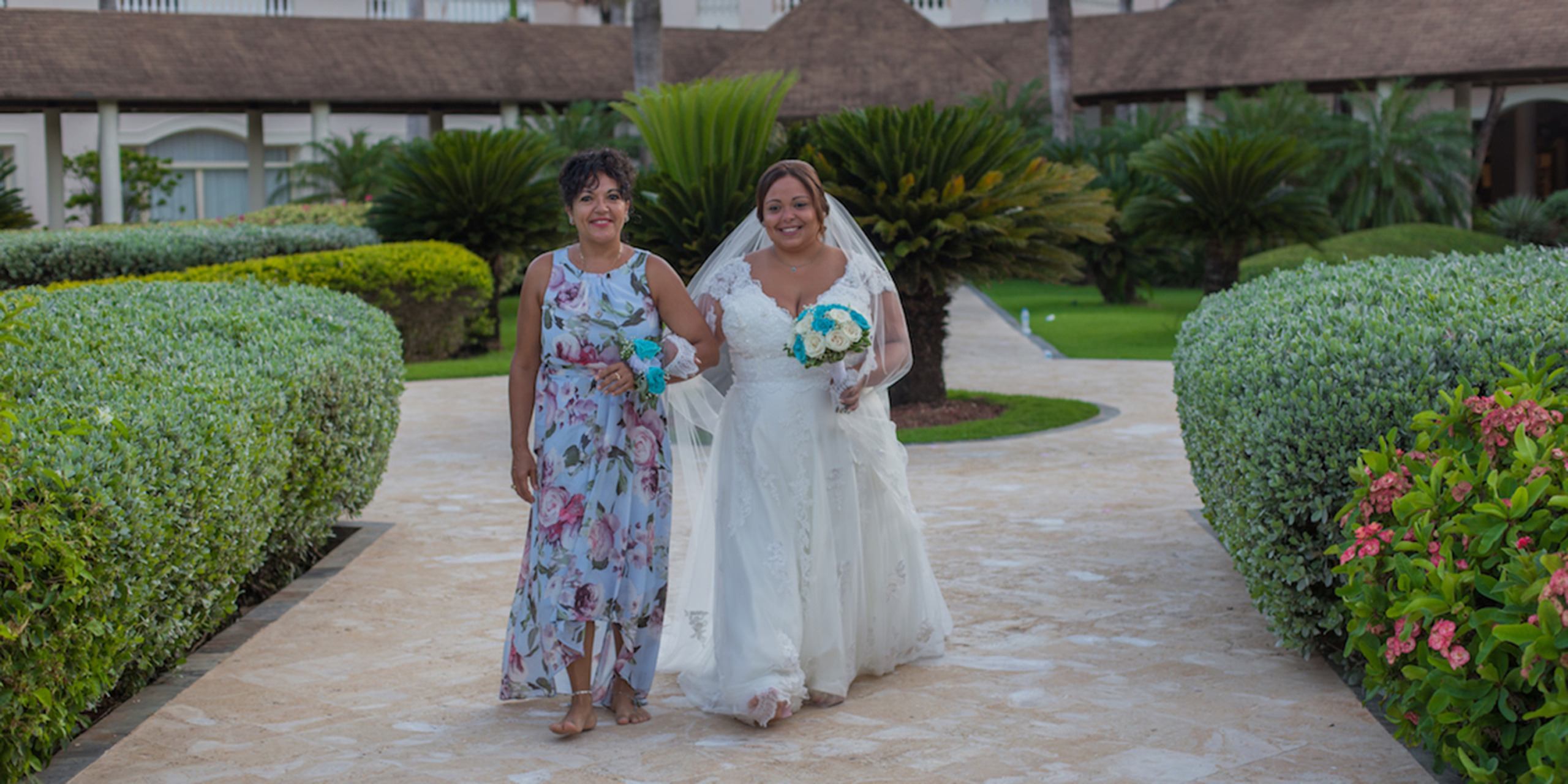 Yolanda's mom walks her down the aisle at the Destify destination wedding of Yolanda and Brett