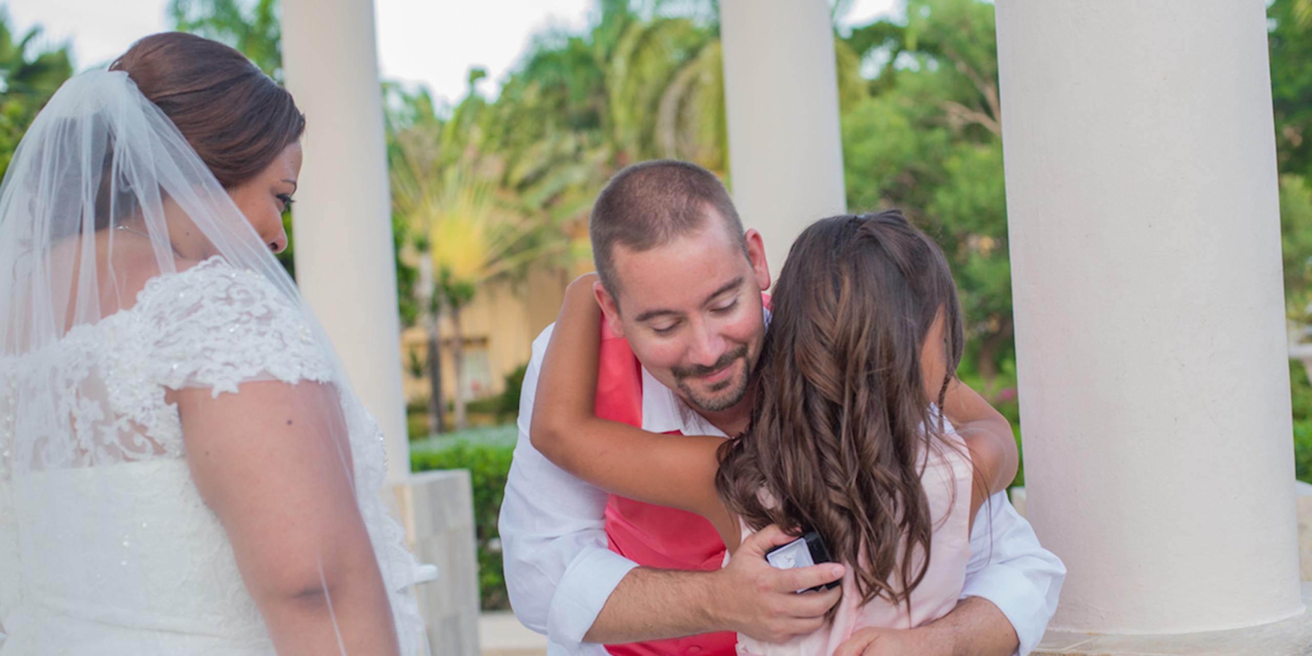 Brett embraces his daughter as Newlyweds Yolanda and Brett get married at a destination wedding thanks to Destify.