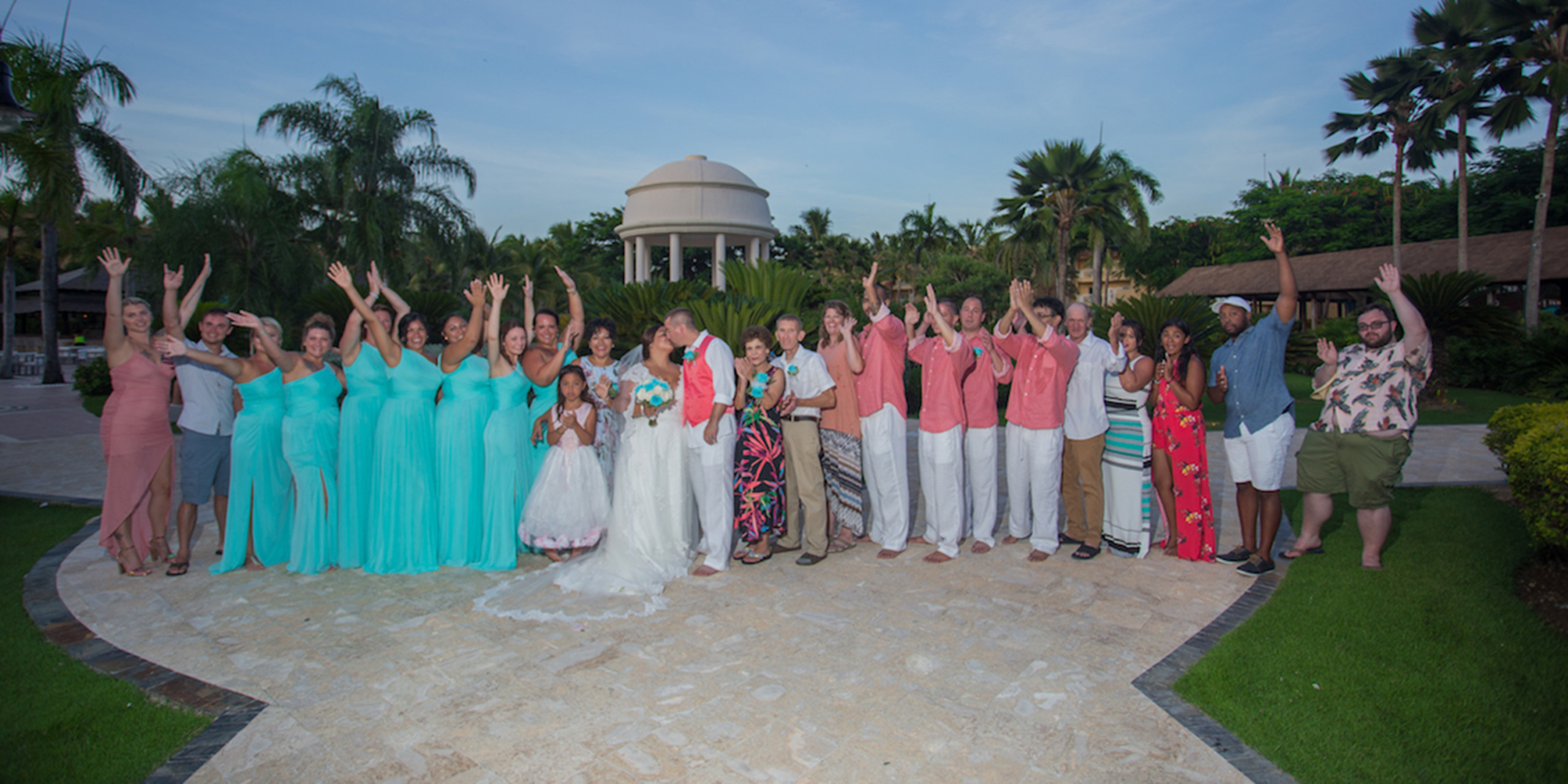The wedding party celebrate Newlyweds Yolanda and Brett kiss after getting married at a destination wedding thanks to Destify.