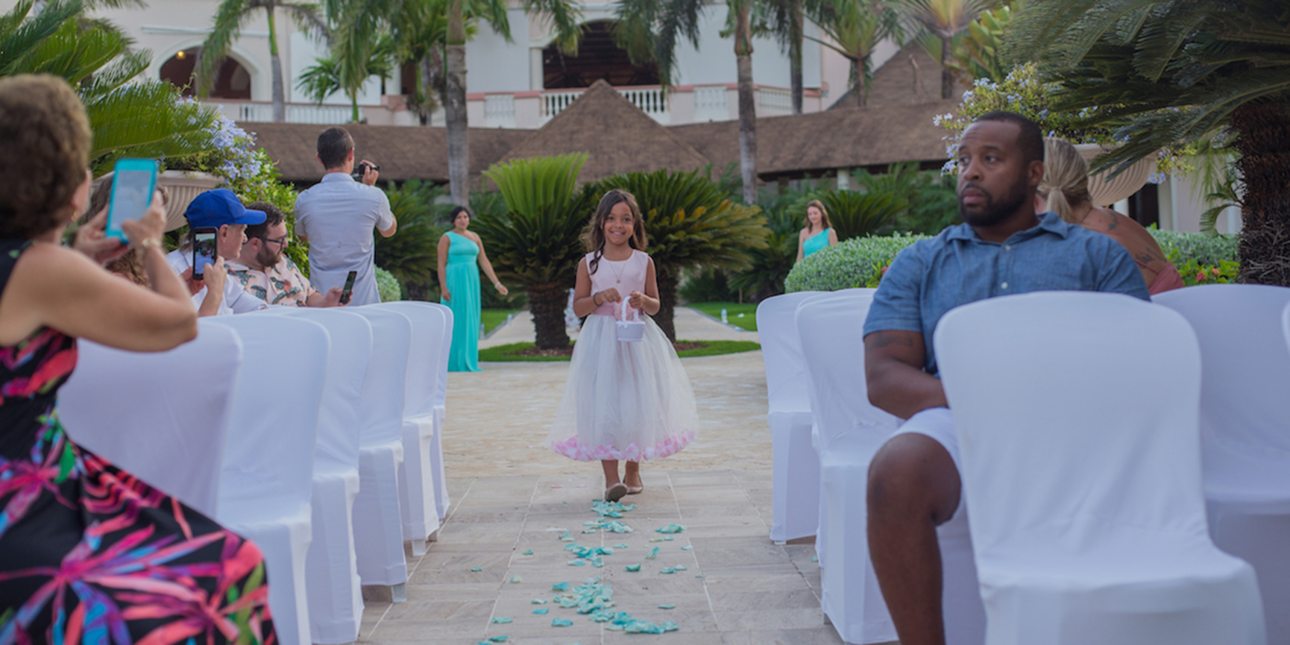 Cute little flower girl walks down the aisle at the Destify destination wedding at Yolanda and Brett's wedding