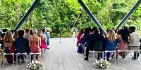 Guests attending a destination wedding at Hilton Tulum Riviera Maya Resort during a lush outdoor ceremony.