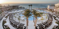 Le Blanc Spa Resort Los Cabos pool with palm trees and cabanas, perfect for a destination wedding sunset.