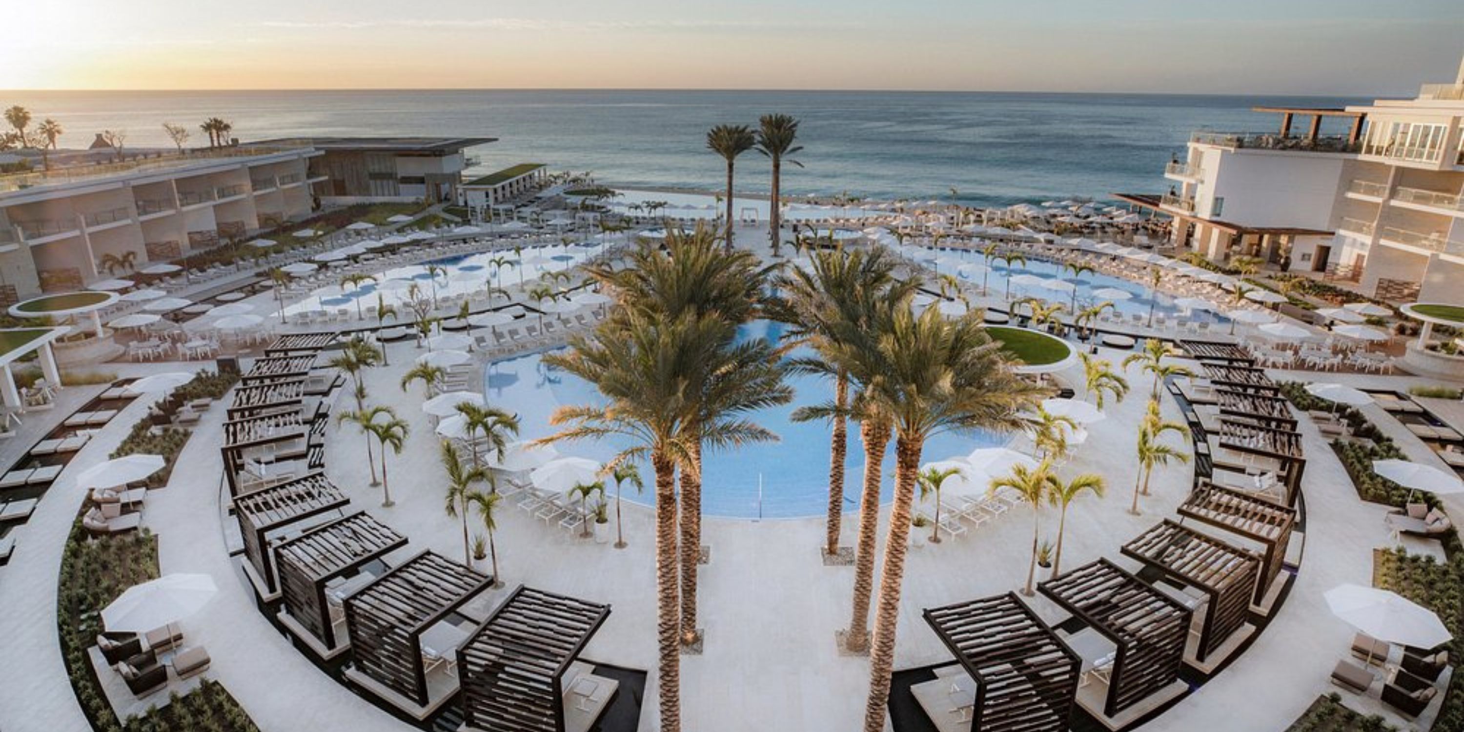Le Blanc Spa Resort Los Cabos pool with palm trees and cabanas, perfect for a destination wedding sunset.