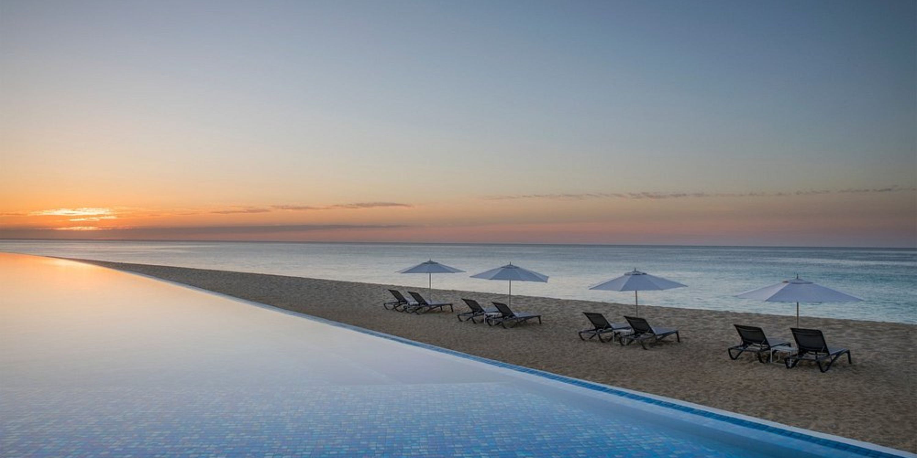 Infinity pool at Le Blanc Spa Resort Los Cabos, perfect for a destination wedding, with beach views.