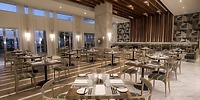 Elegant dining area at Le Blanc Spa Resort Los Cabos, perfect for a destination wedding, with set tables and large windows.