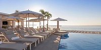 Le Blanc Spa Resort Los Cabos: poolside loungers and umbrellas overlook the ocean, ideal for a wedding.