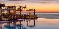 Infinity pool at Le Blanc Spa Resort Los Cabos, a stunning destination wedding spot at sunset.