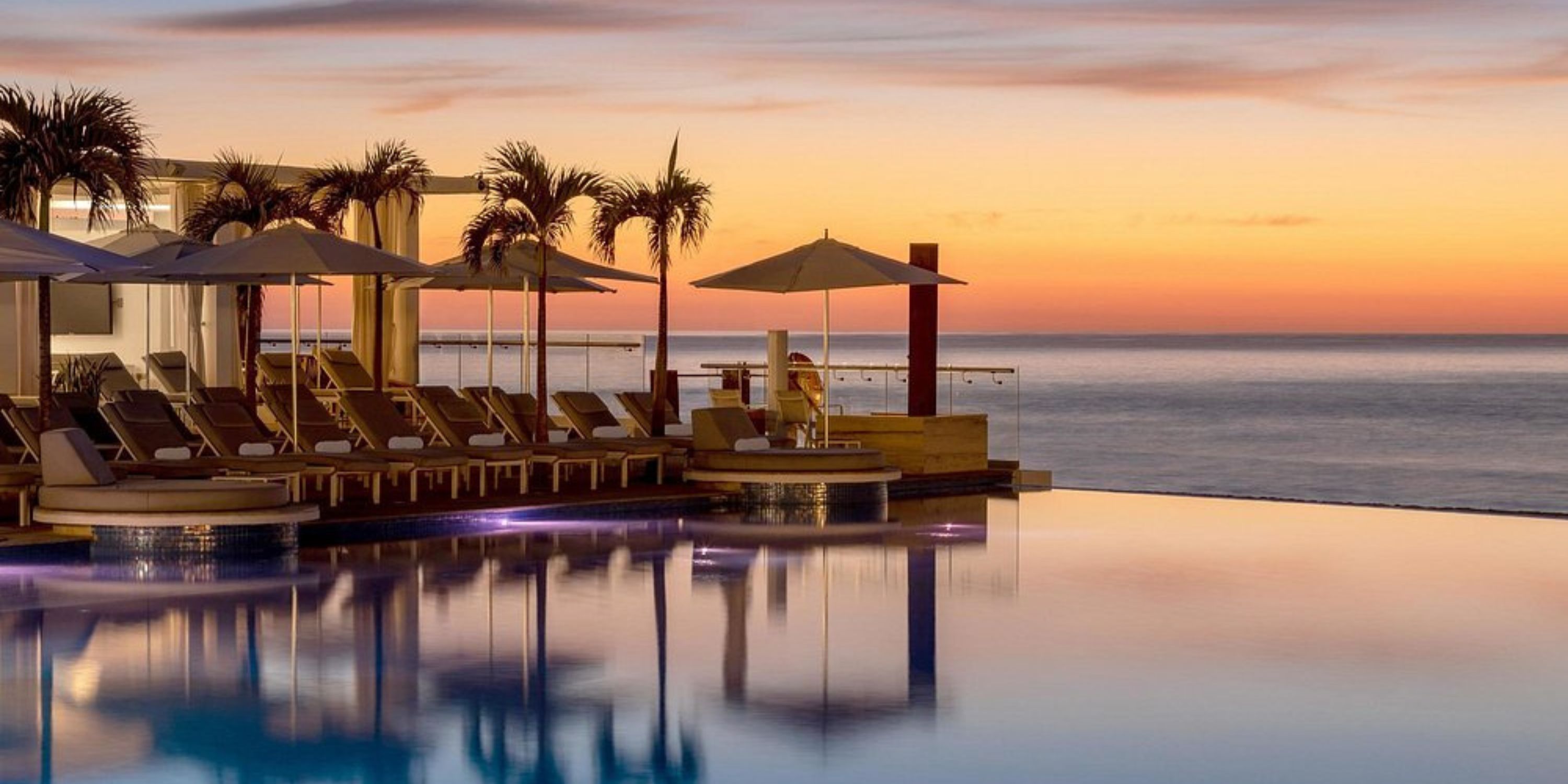 Infinity pool at Le Blanc Spa Resort Los Cabos, a stunning destination wedding spot at sunset.