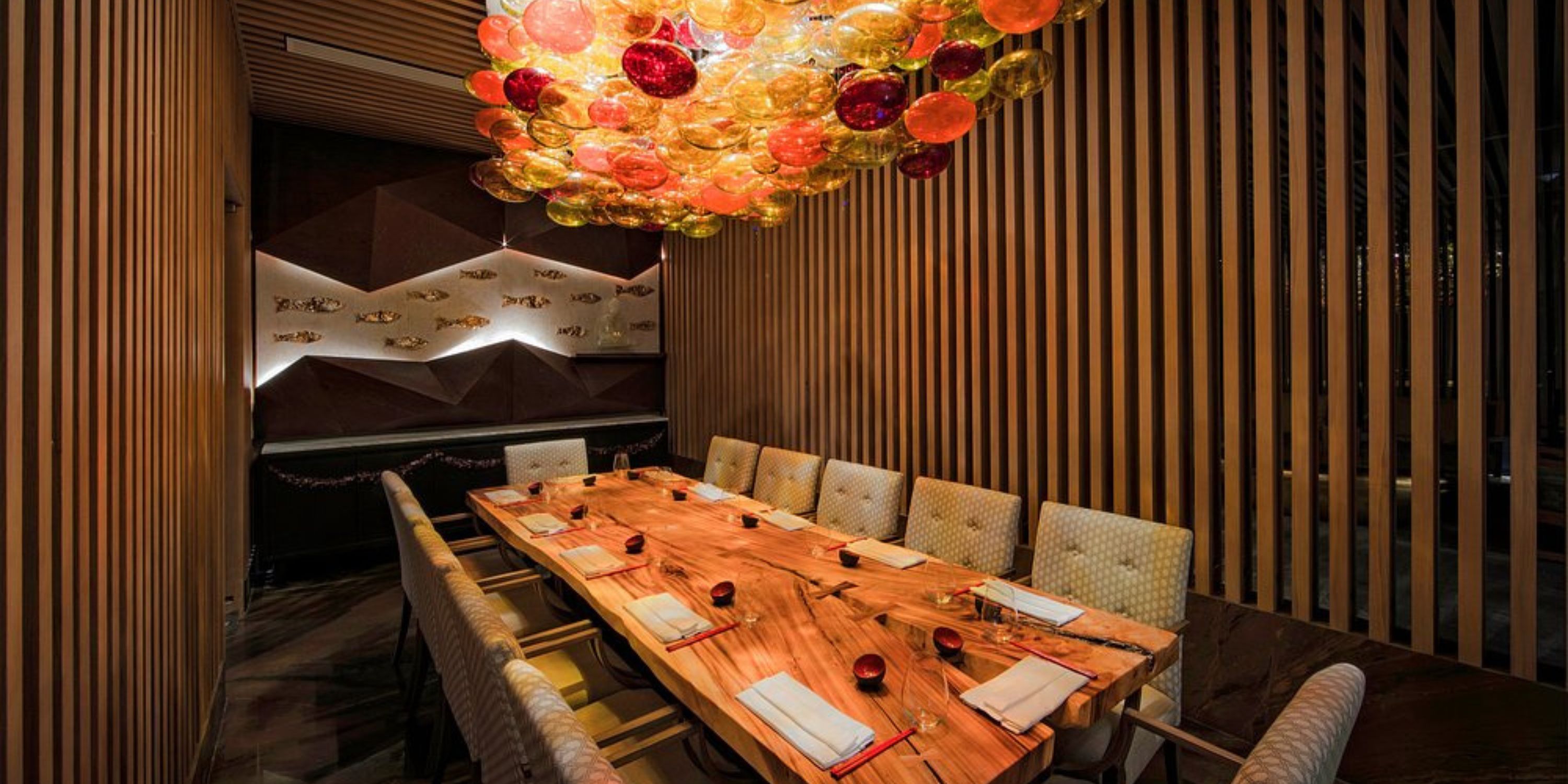 Le Blanc Spa Resort Los Cabos is a wedding destination with wood tables, chairs, and colorful lights.