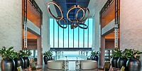 Elegant hotel lobby at Le Blanc Spa Resort Los Cabos, ideal for destination weddings, ocean view, circular lights.