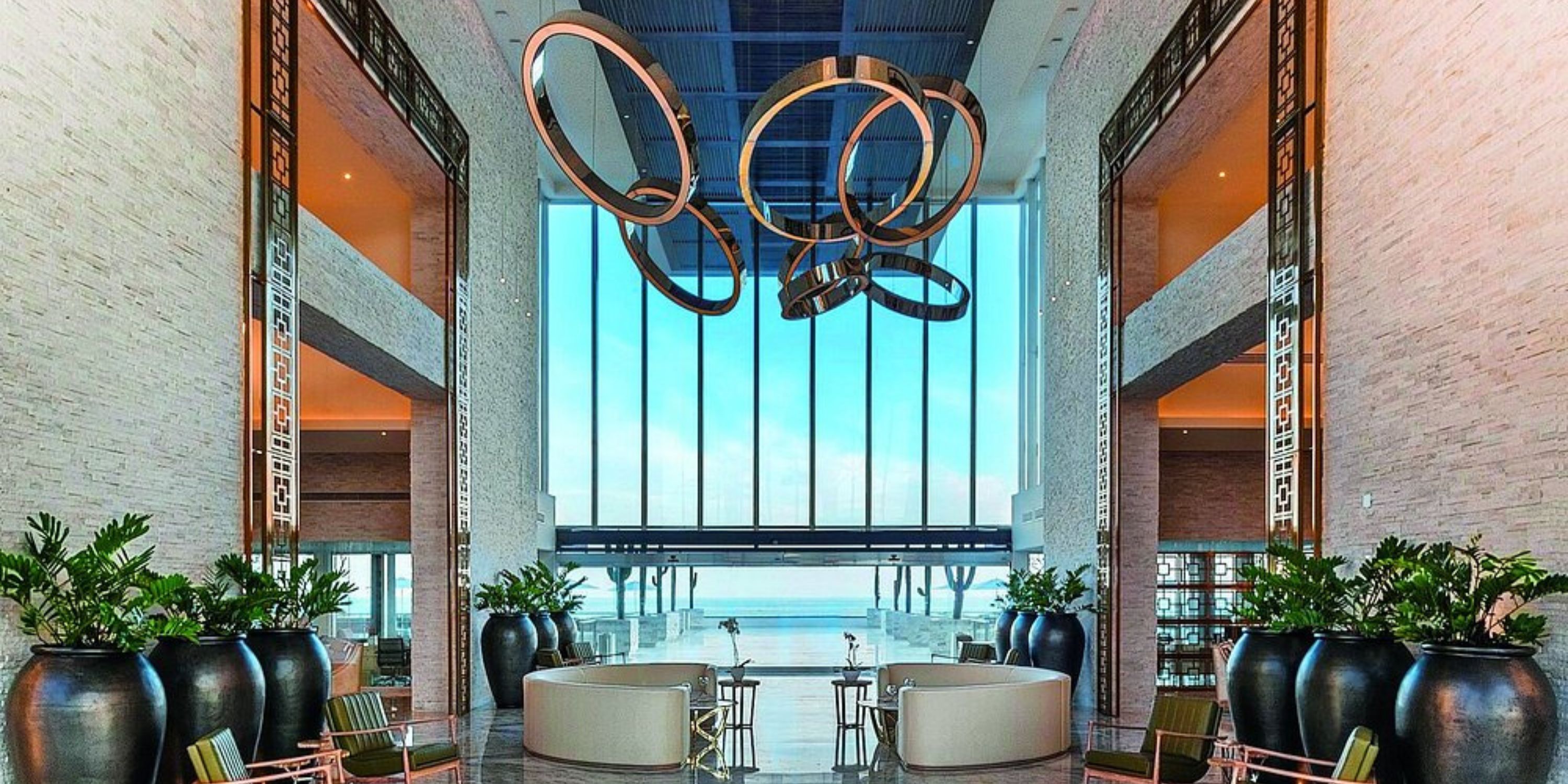 Elegant hotel lobby at Le Blanc Spa Resort Los Cabos, ideal for destination weddings, ocean view, circular lights.