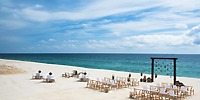 Destination wedding seating at Le Blanc Spa Resort Los Cabos overlooking the ocean under a clear blue sky.