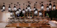 Chic bar at Le Blanc Spa Resort Los Cabos, perfect for a destination wedding, with metal chairs and lanterns.