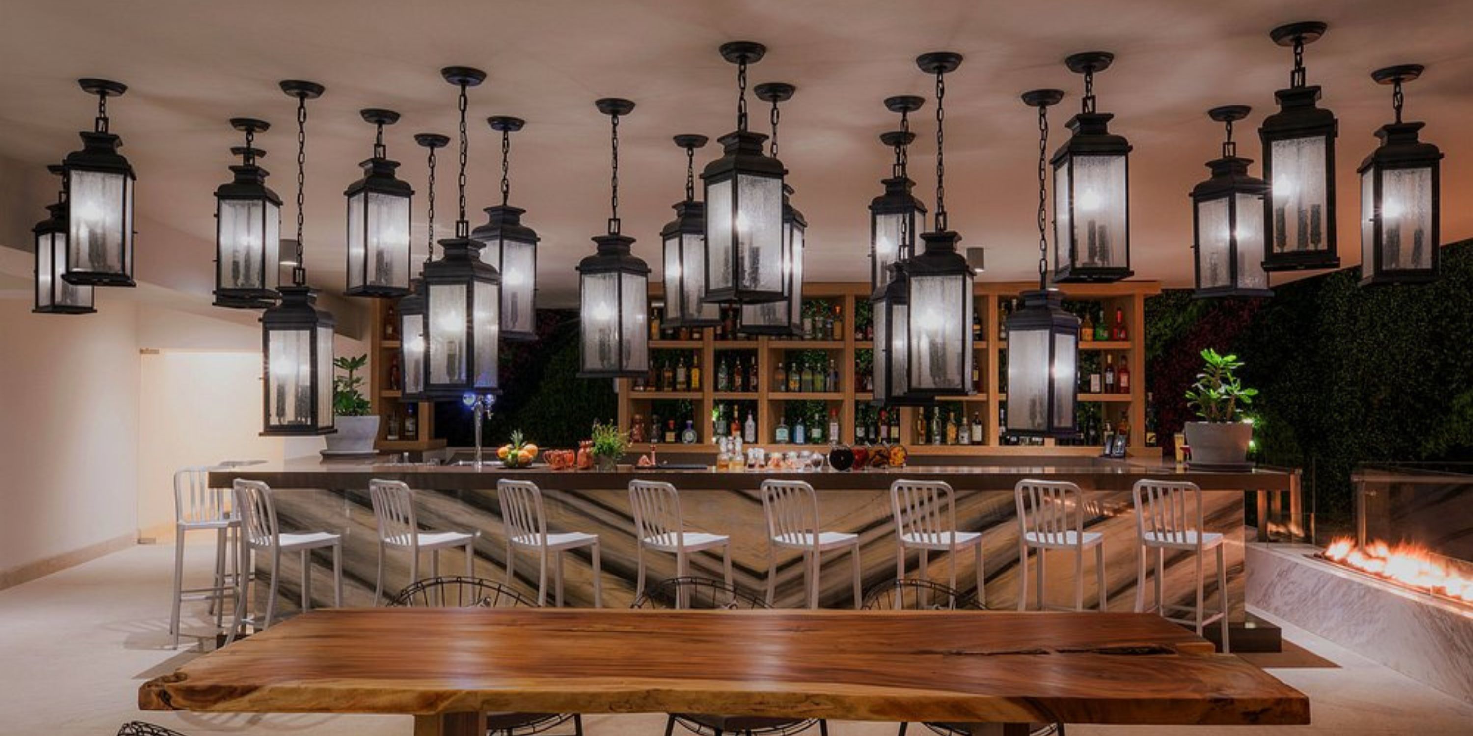 Chic bar at Le Blanc Spa Resort Los Cabos, perfect for a destination wedding, with metal chairs and lanterns.