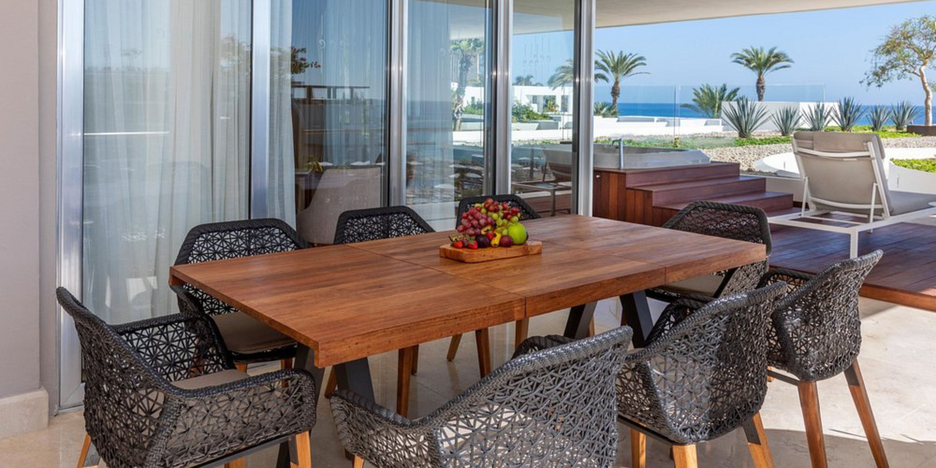 Le Blanc Spa Resort Los Cabos: patio dining for six, fruit bowl, ocean view—ideal for a destination wedding.