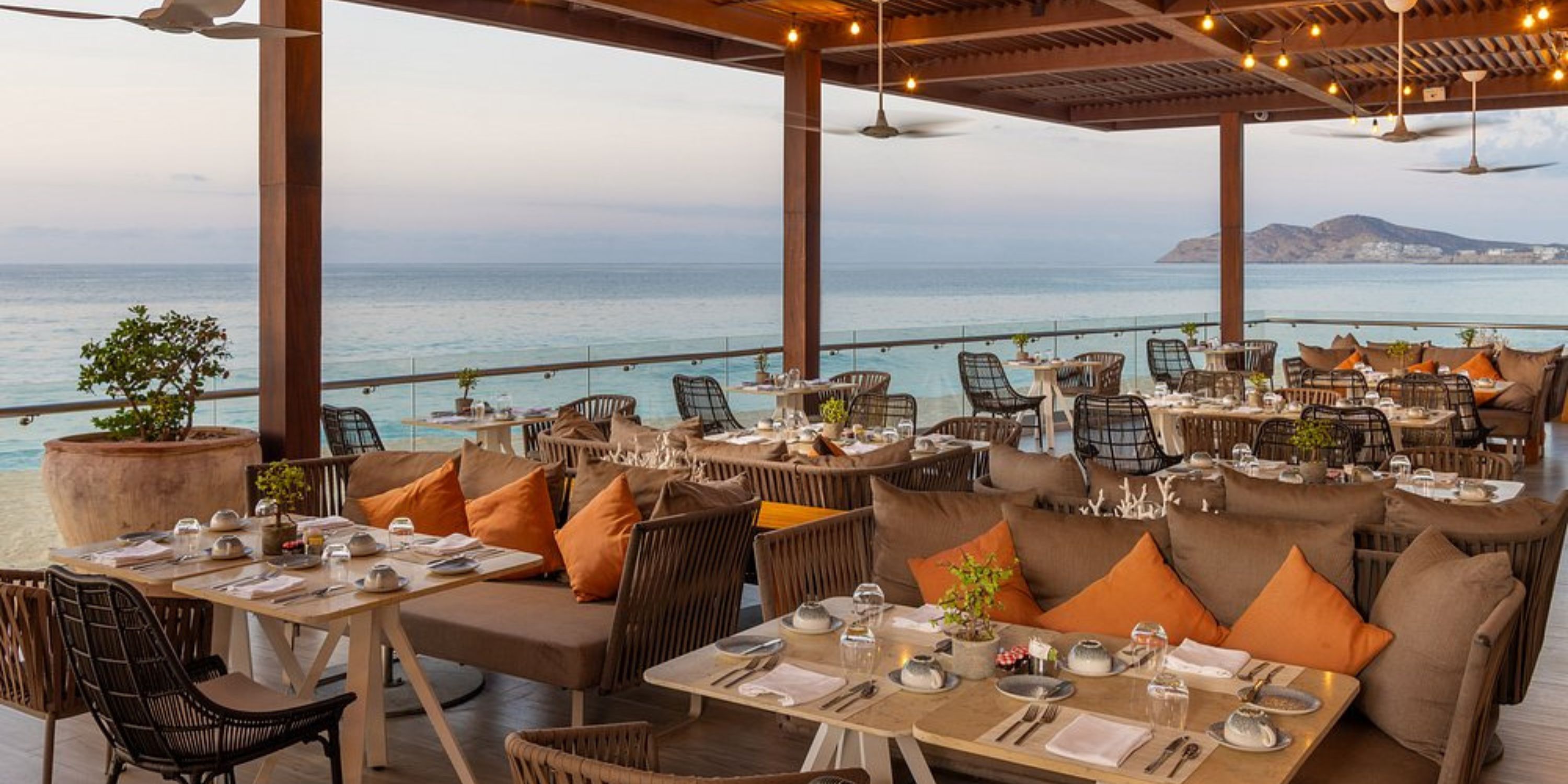 Le Blanc Spa Resort Los Cabos: destination wedding ocean-view dining with set tables and string lights.