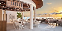 Le Blanc Spa Resort: Elegant white chairs and tables set for a destination wedding, overlooking the ocean at sunset—an adults-only paradise.