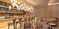 Le Blanc Spa Resort offers a stylish hotel bar with an illuminated counter and elegant lounge seating, providing the perfect setting for wedding celebrations or destination weddings.