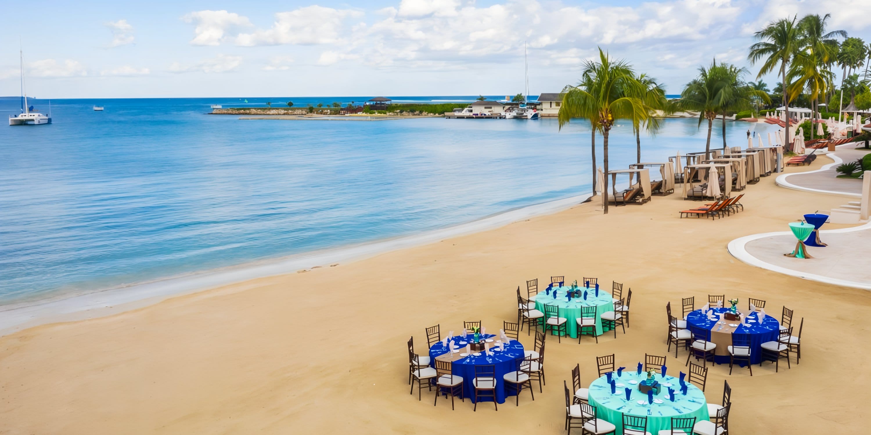 Round tables set for a destination wedding at Moon Palace Jamaica with ocean views.