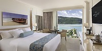 Modern room at Moon Palace Jamaica, perfect for a destination wedding, with large bed and balcony views.