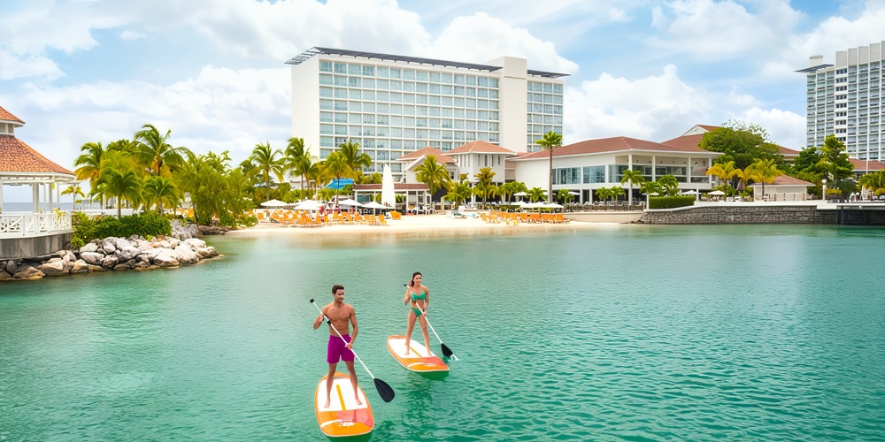 Enjoy paddleboarding under clear skies near Moon Palace Jamaica, the perfect setting for a memorable destination wedding.