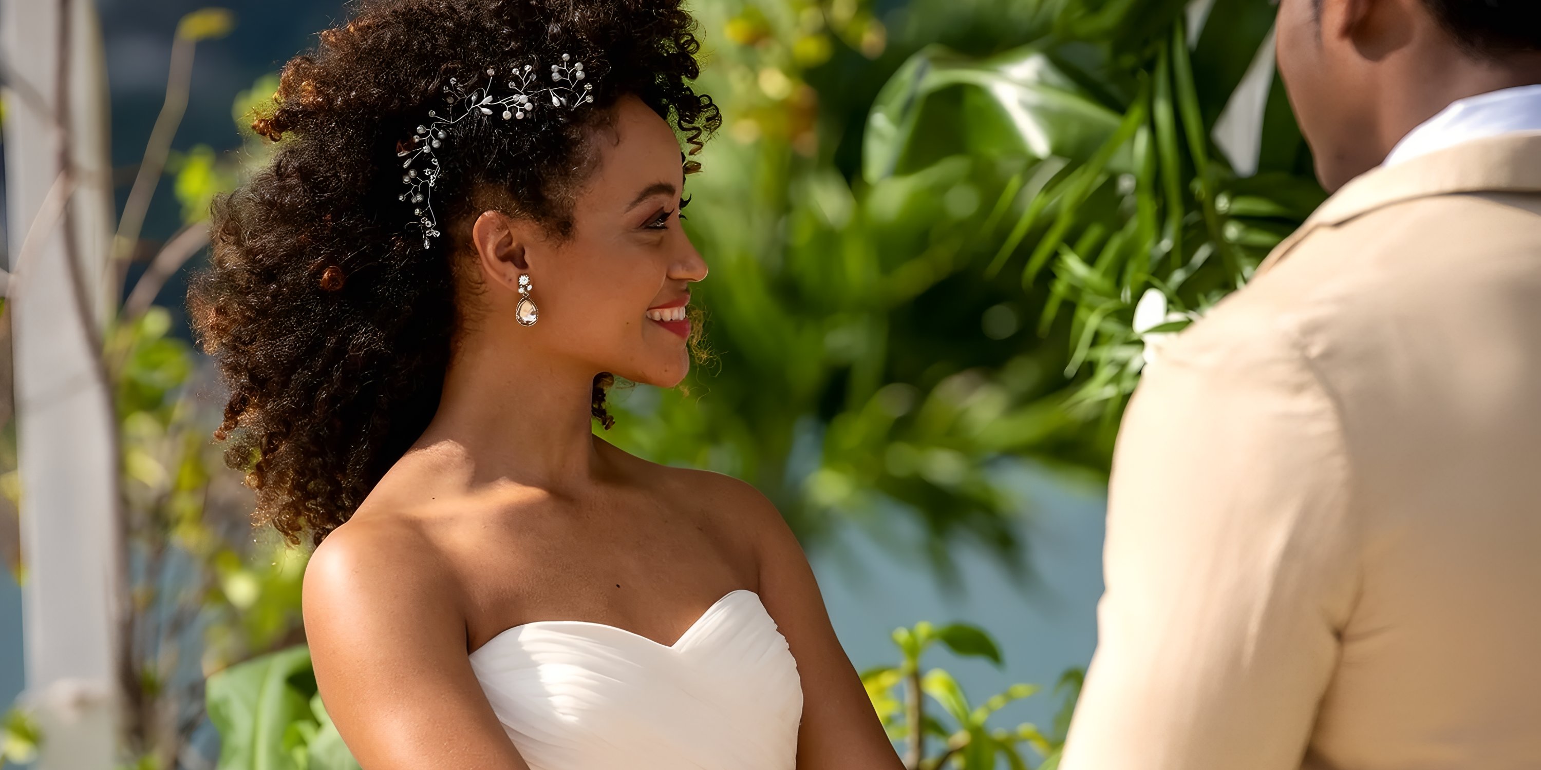 Bride in strapless white dress smiling with partner during their destination wedding at Moon Palace Jamaica.