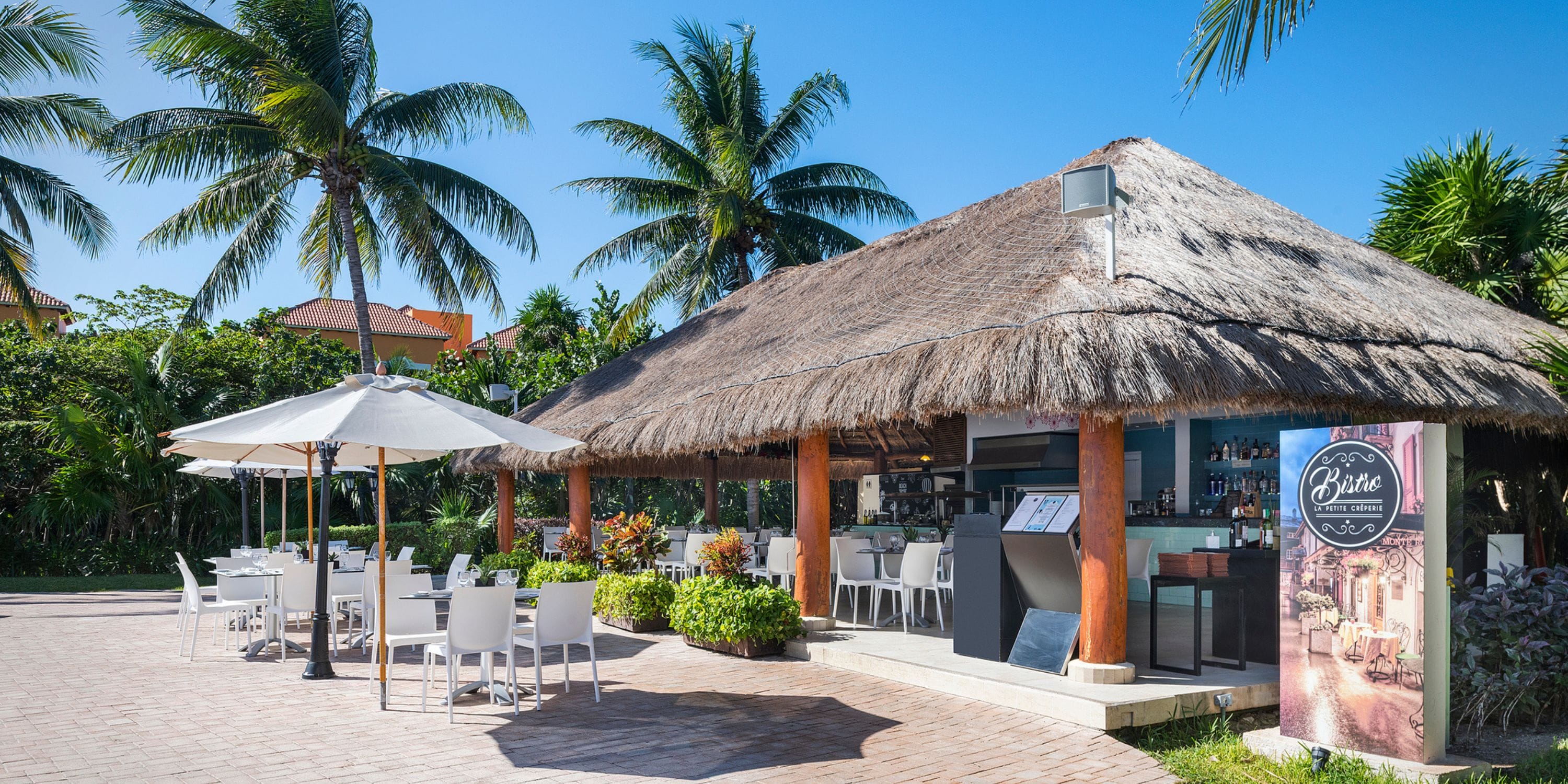 Ocean Coral and Turquesa: thatched-roof bar with patio seating, perfect for a destination wedding.