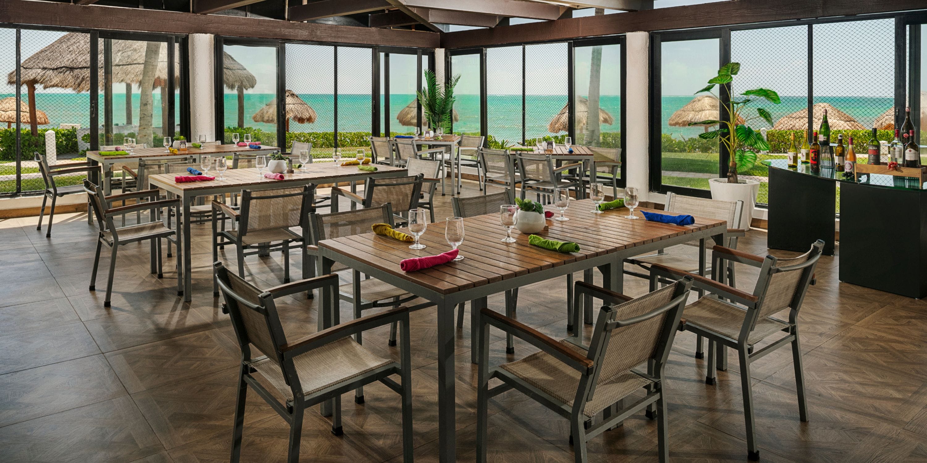 Ocean Coral and Turquesa: elegant beachfront dining set for a destination wedding, ocean views beyond.