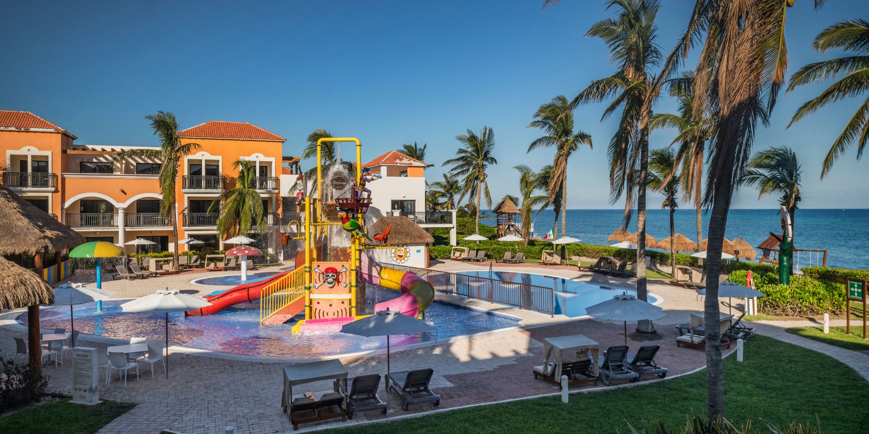 Ocean Coral and Turquesa offers a wedding-friendly water play area with slides, lounge chairs, and palm trees.