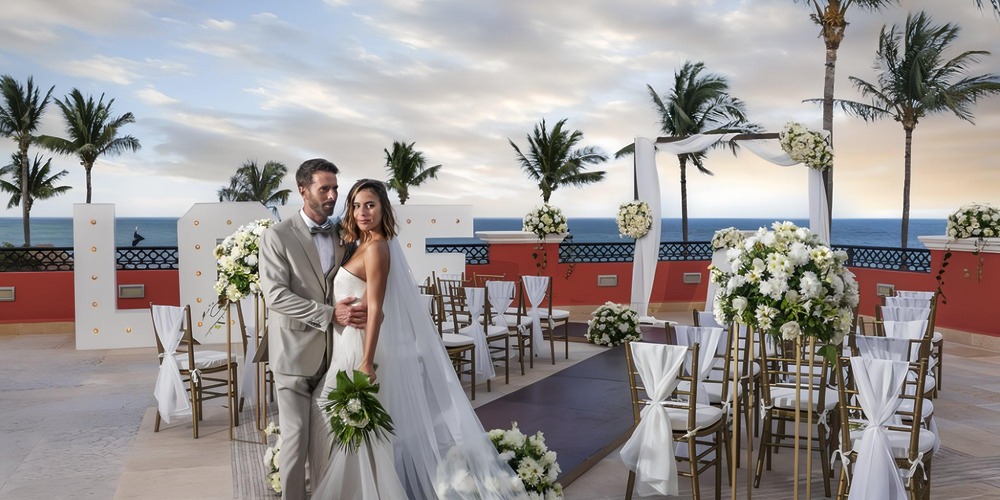 Bride and groom at their destination wedding at Ocean Coral and Turquesa, white flowers, ocean view.