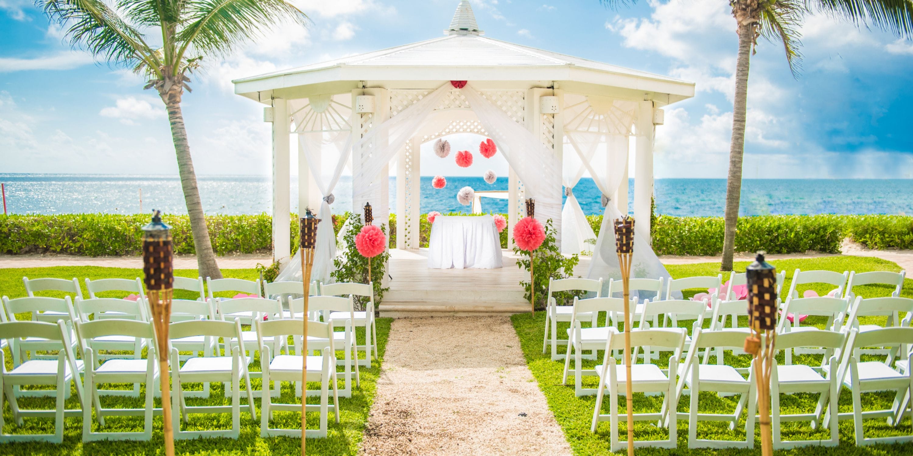 Gazebo at Ocean Coral and Turquesa set for a destination wedding, with chairs and ocean backdrop.