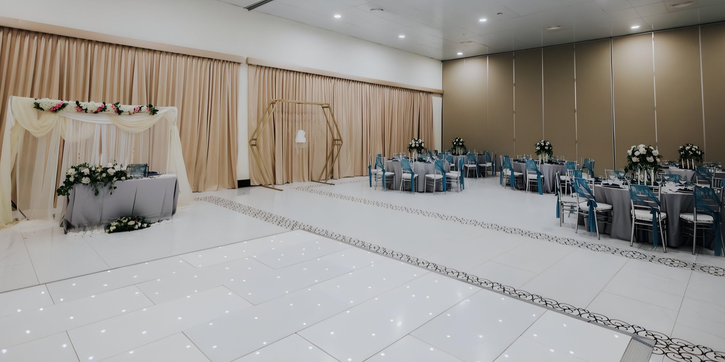 Ocean El Faro banquet hall set for a destination wedding, featuring decorated tables and floral arch.