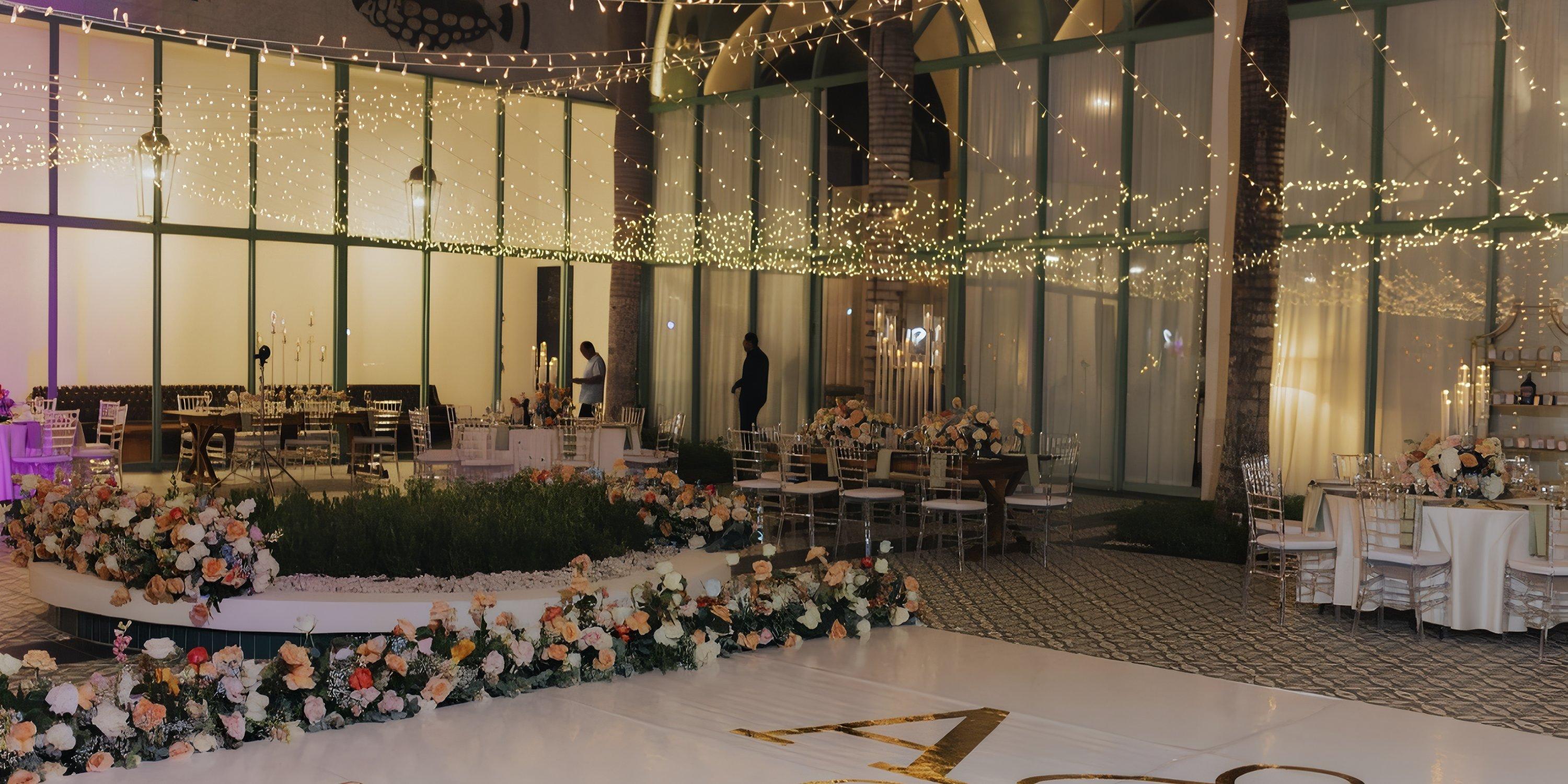 Ocean El Faro: Chic indoor wedding venue with floral d&eacute;cor, round tables, and glowing string lights above.