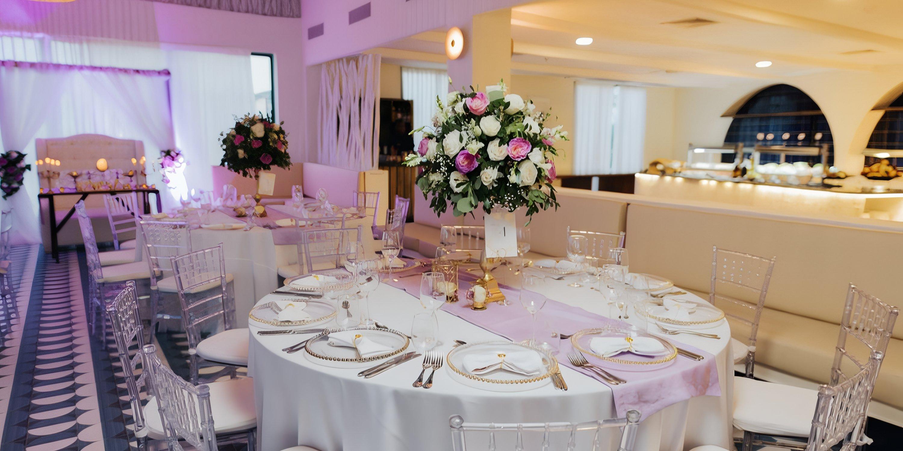 Banquet table at Ocean El Faro set for a destination wedding, with white cloth, florals, and place settings.