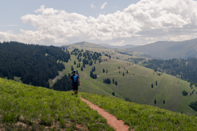 Colorado mountains and hiking trail with a hiker 5 Amazing Things To Do in Vail, CO