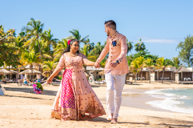 hyatt ziva rose hall indian couple walking on beach holding hands