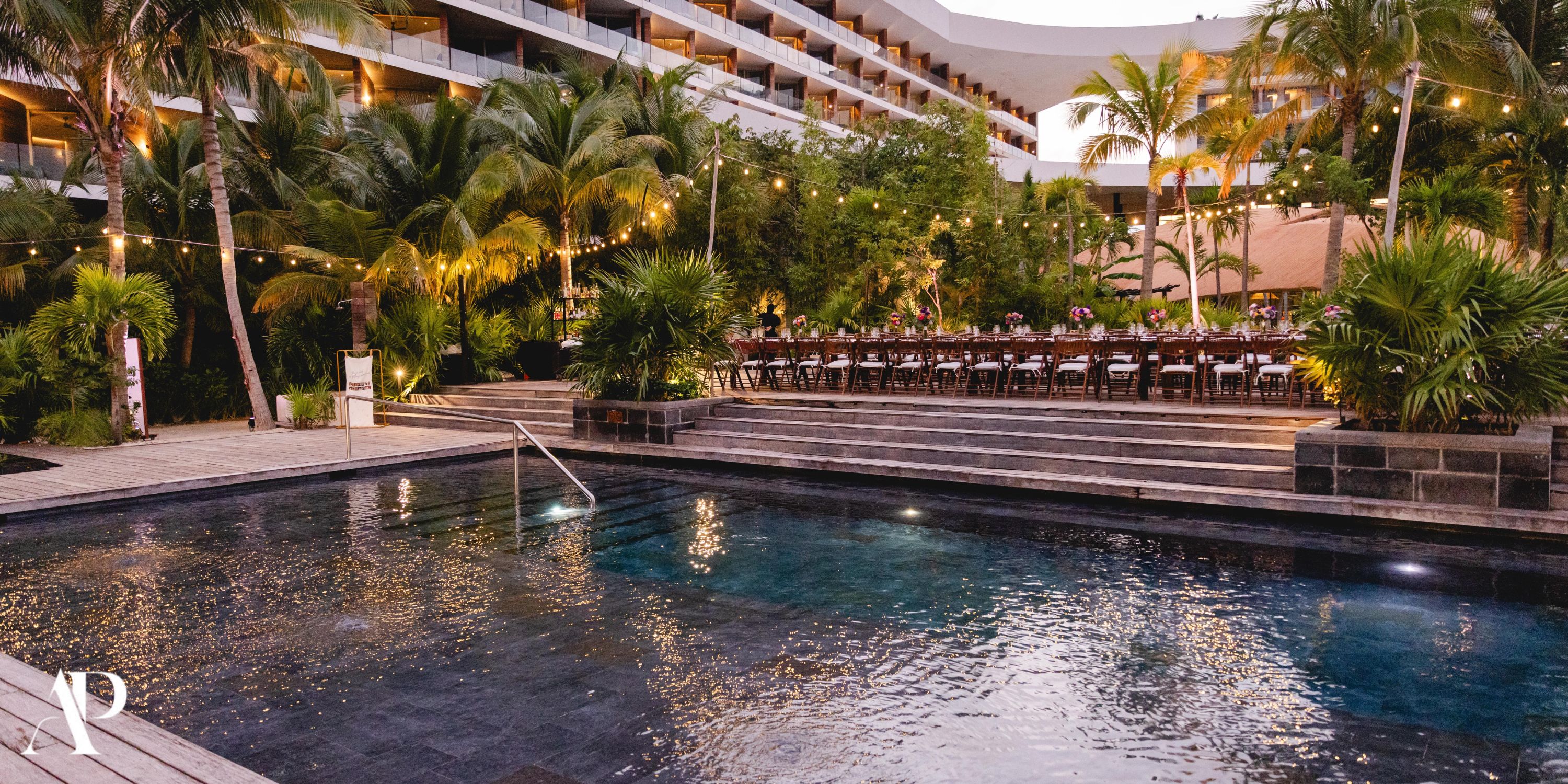 Secrets Moxche Playa del Carmen: dreamy outdoor pool with string lights and palm trees, perfect for a destination wedding at dusk.