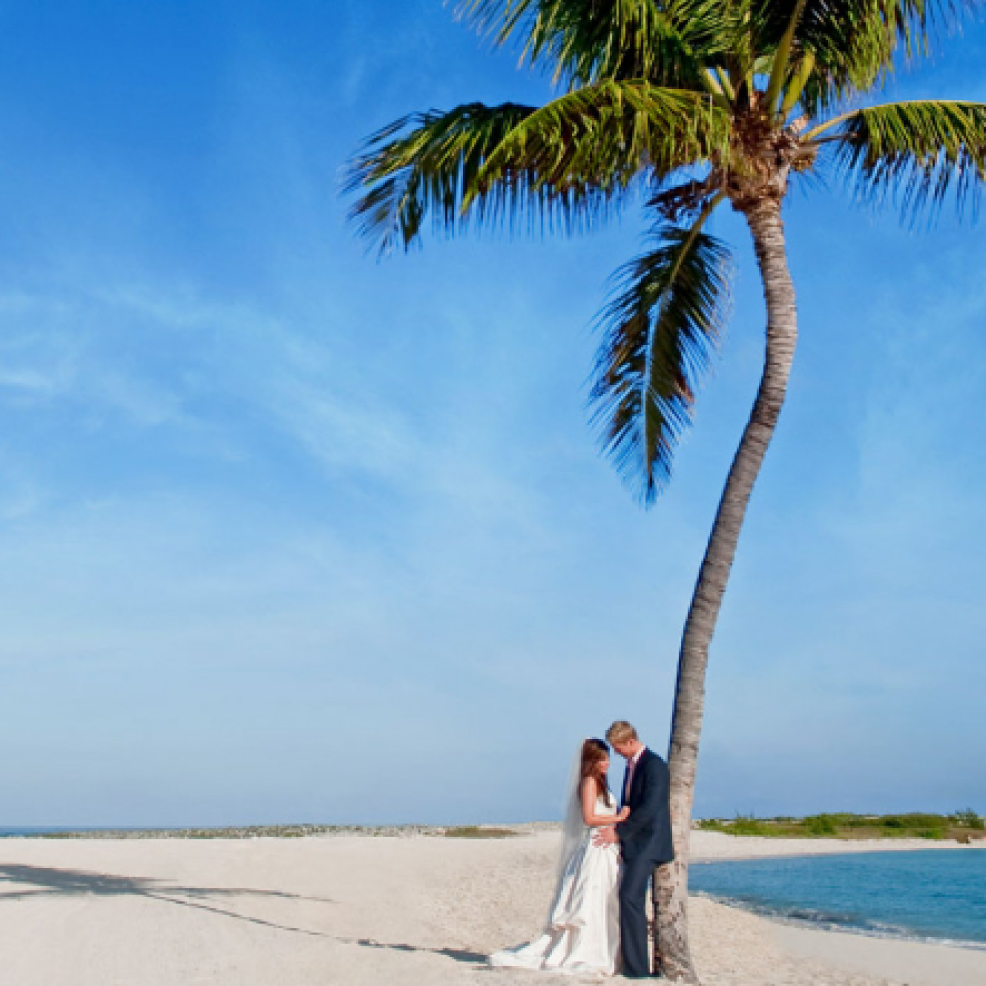 Intimate newlywed couple at Palm Point beach destination wedding venue at Bahamas Atlantis resort